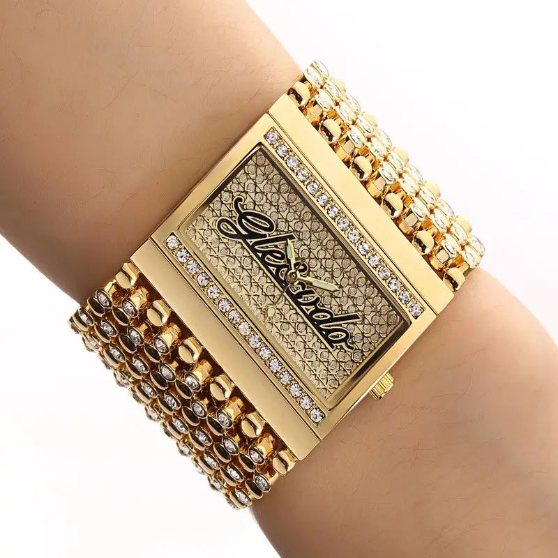 Gold quartz women watch with a gold-tone rectangular diamond-encrusted face and a multi-layered beaded band.
