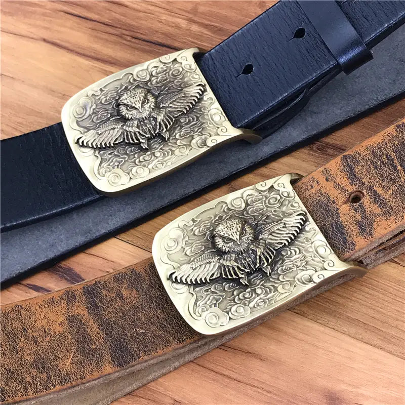 Two intricately engraved brass owl belt buckles featuring detailed flying owls and swirling cloud patterns on rectangular plates for genuine leather men jeans belts.