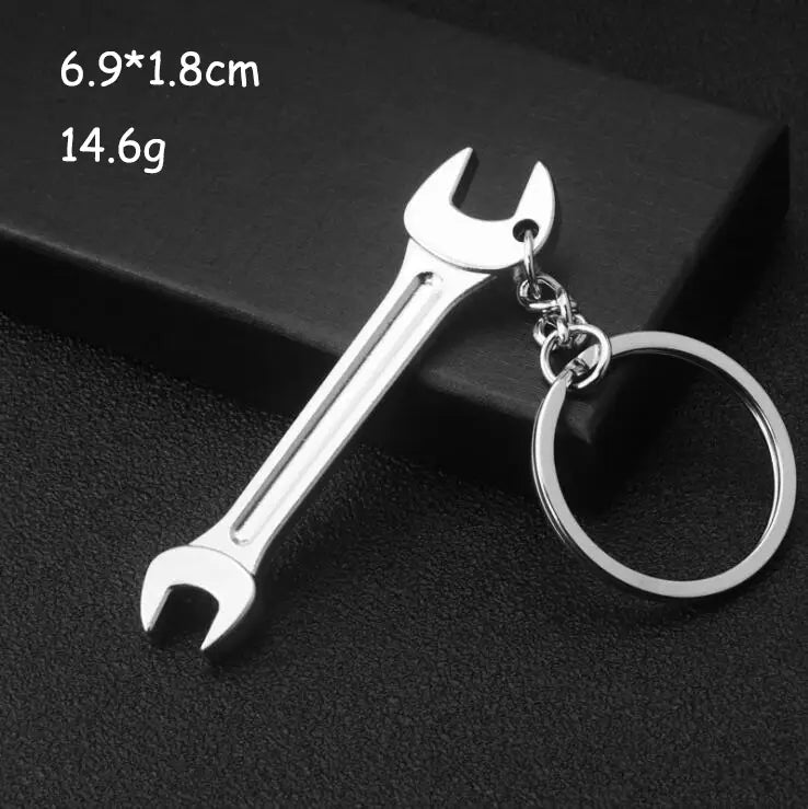 Silver metallic wrench-shaped mini tool keychain set with polished finish and attached chain ring made of metal.
