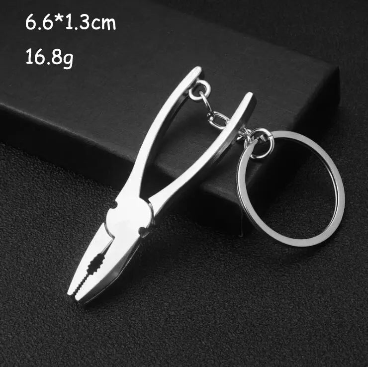 Silver-colored metal mini tool keychain designed as a multi-tool key ring shaped like miniature pliers.