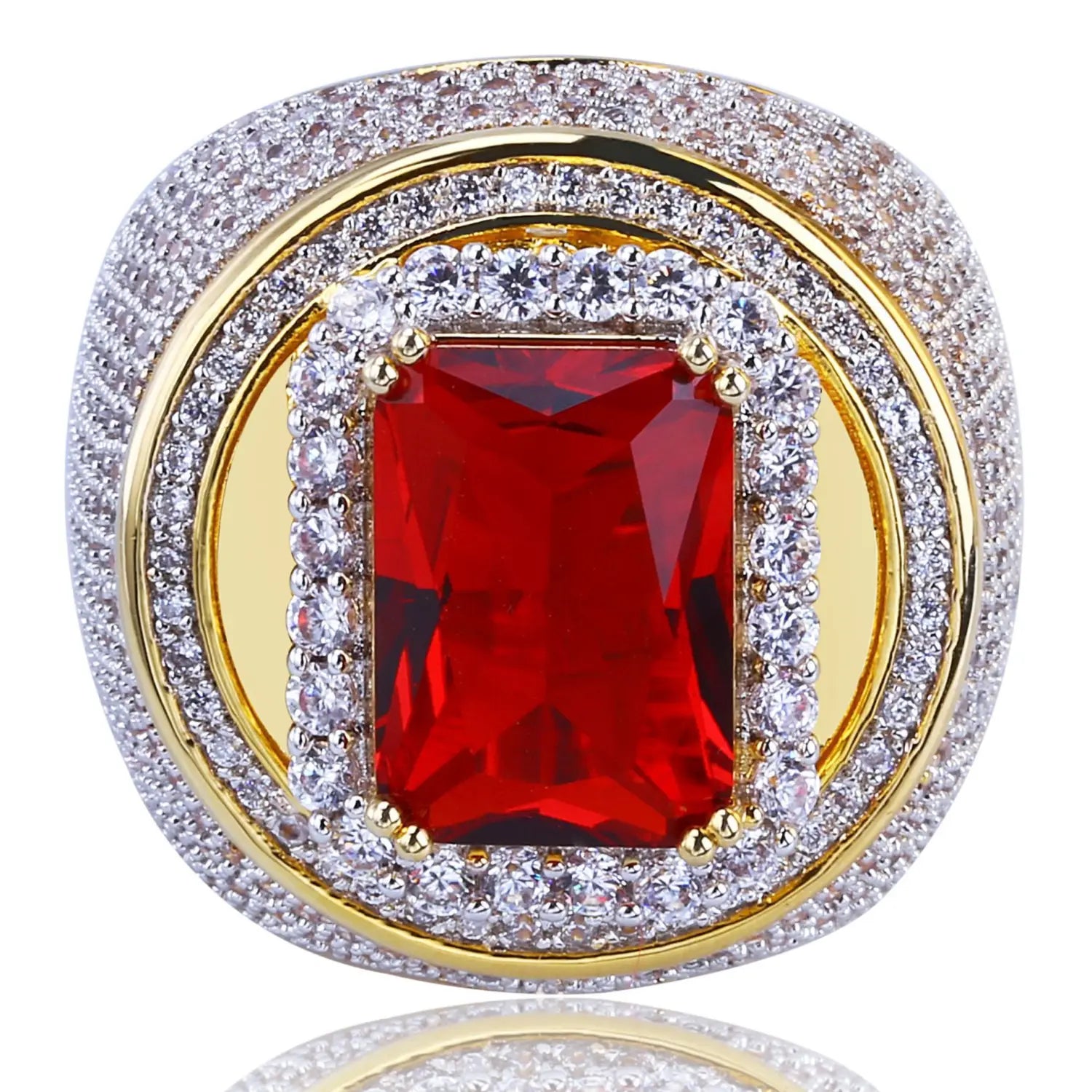 A bold gold filled statement ring featuring a central emerald cut red gemstone surrounded by two concentric bands of pave set clear crystals.