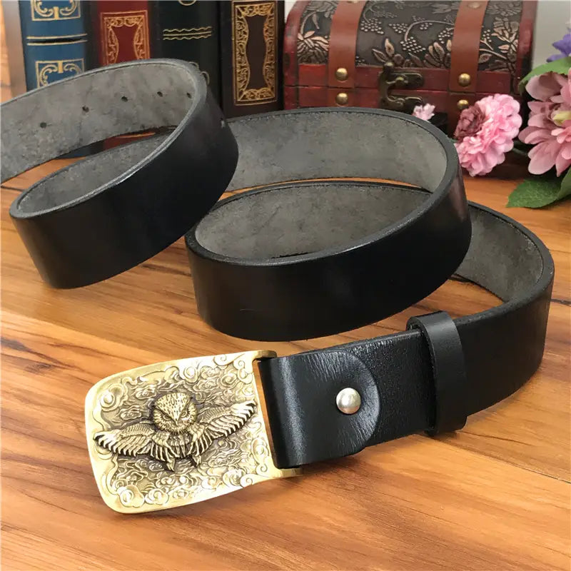Black leather belt with a detailed gold-toned brass owl buckle designed for men jeans.