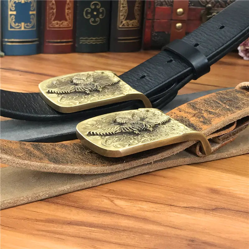 Two brass eagle buckle belts with genuine leather straps in black and aged tan designed for men jeans belt use.