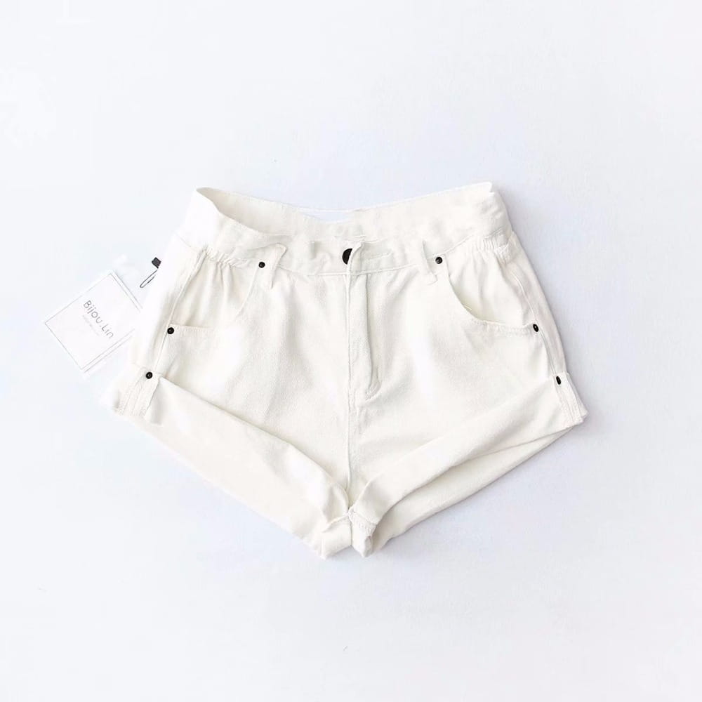 Cream-colored high waist denim shorts for women feature black button accents and a relaxed tapered fit in cotton fabric with standard length inch-cm and available tag size for casual wear within business days delivery.