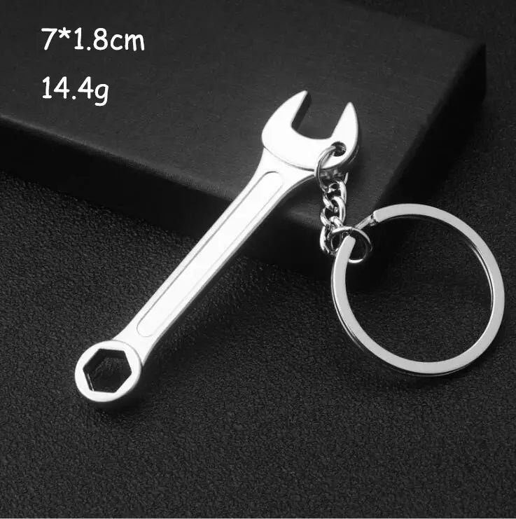 Silver metallic wrench-shaped keychain made of metal with a chain and ring from the mini tool keychain set metal multi-tool key ring.
