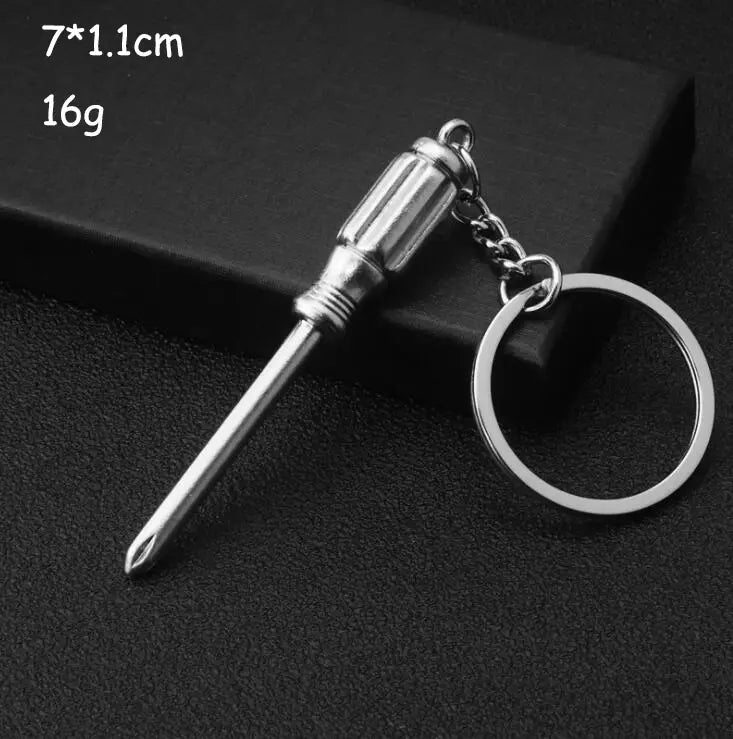Silver screwdriver-shaped keychain from mini tool keychain set with polished metallic finish and detailed grooves along the handle.
