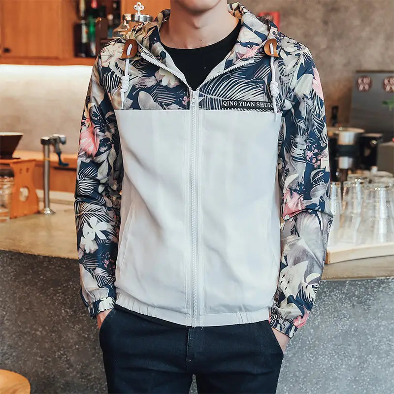 A stylish mens hooded jacket asia size featuring a bold tropical floral pattern on the sleeves and hood with a solid white front panel lightweight windbreaker.