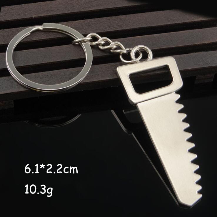 Silver metallic keychain shaped like a saw with serrated blade and rectangular handle from the mini tool keychain set metal multi-tool key ring.