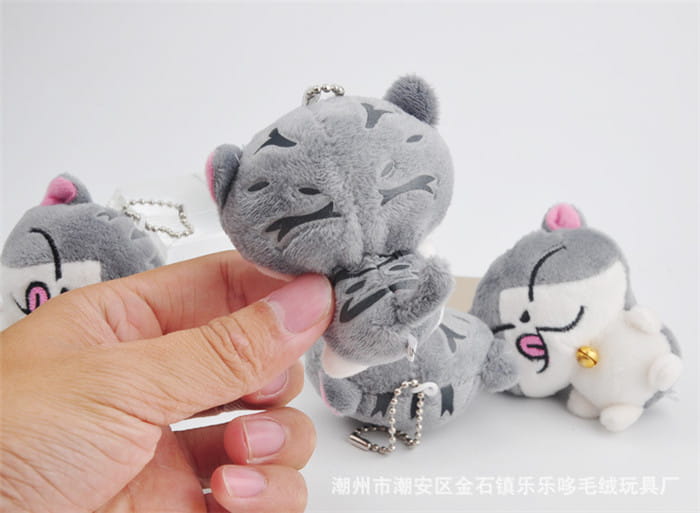 Gray plush cat keychain featuring black embroidered facial features and a silver chain attachment designed as a cute gray kitten bag charm toy.