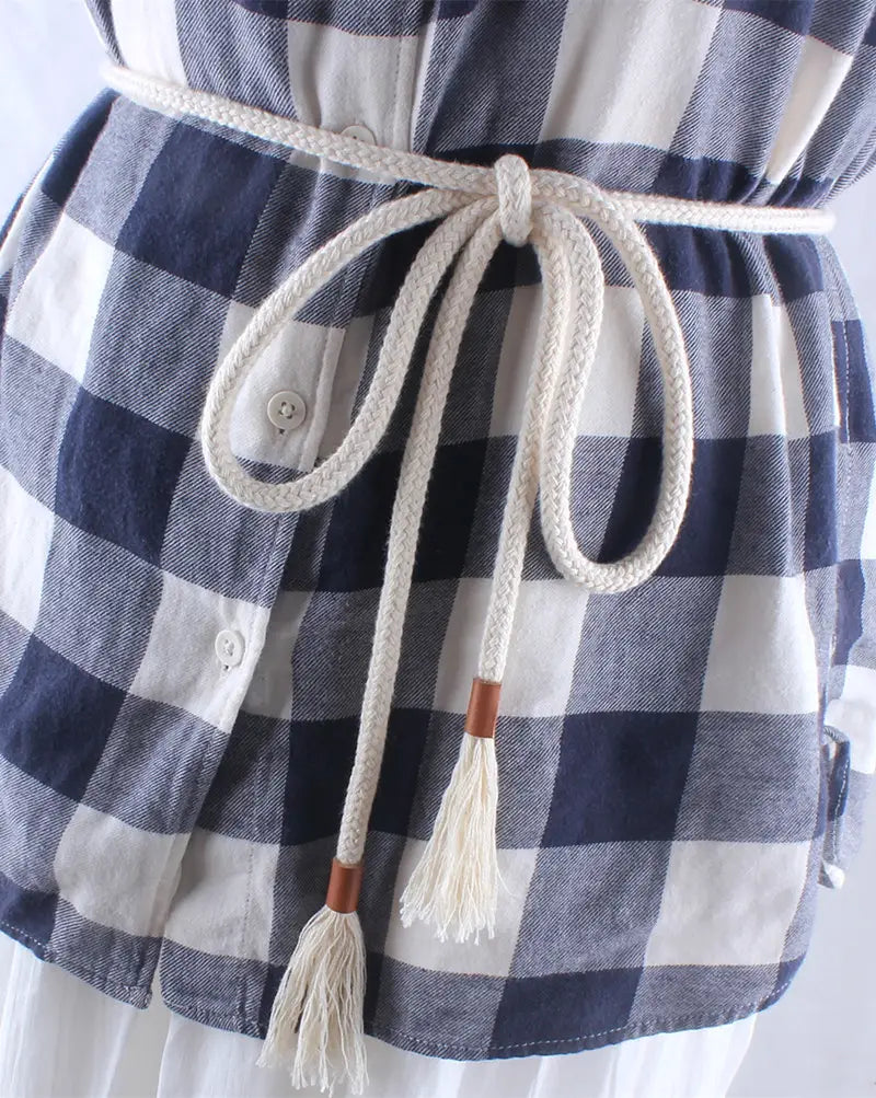 Cream-colored braided rope belt for women featuring wooden toggle ends and tassels as a dress accessory waistband.