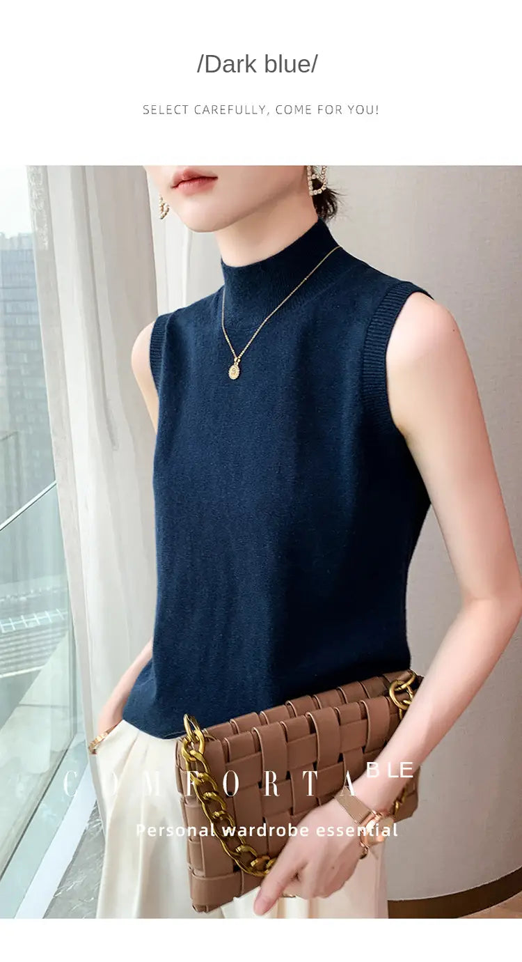 Dark blue sleeveless high-neck knit top made of wool ideal for layering as a turtleneck sleeveless sweater vest.