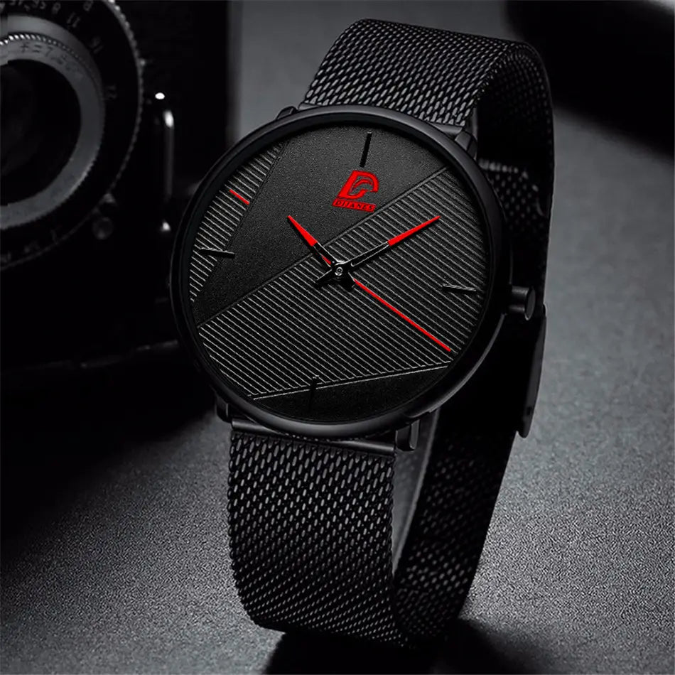 Minimalistische schwarze Quarzarmbanduhr für Herren mit einem strukturierten Zifferblatt und kräftigen roten Zeigern sowie Stundenmarkierungen in einem eleganten, modernen Design.
