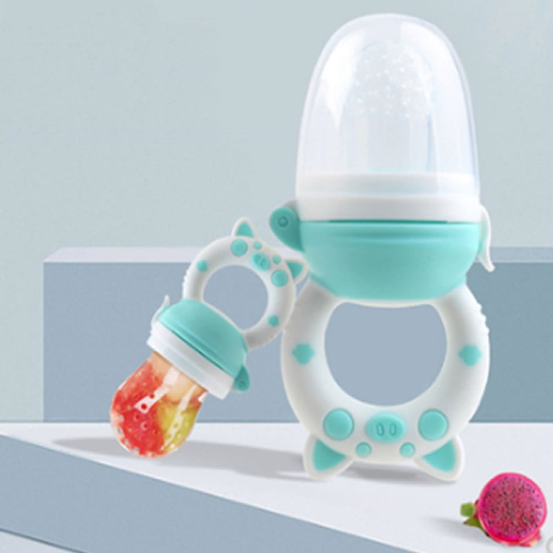 A turquoise and white silicone baby fruit feeder and teether set with a clear dome top featuring cat ear handles and dotted accents.