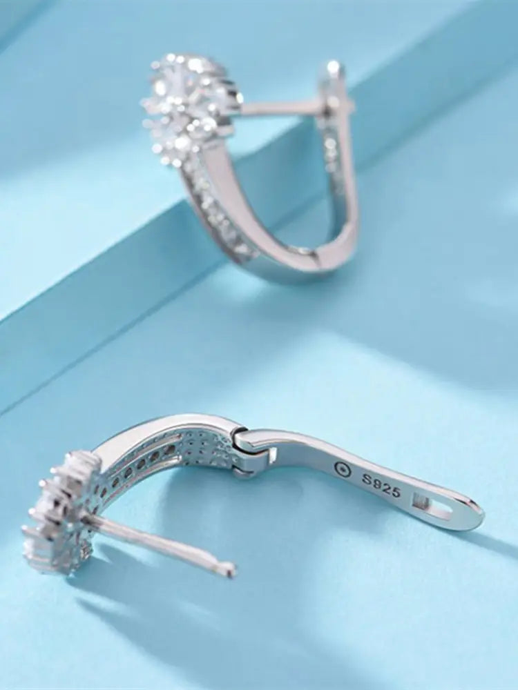 Sterling silver zircon flower hoop earring featuring a silver huggie design with a floral pattern adorned with clear cubic zirconia stones.