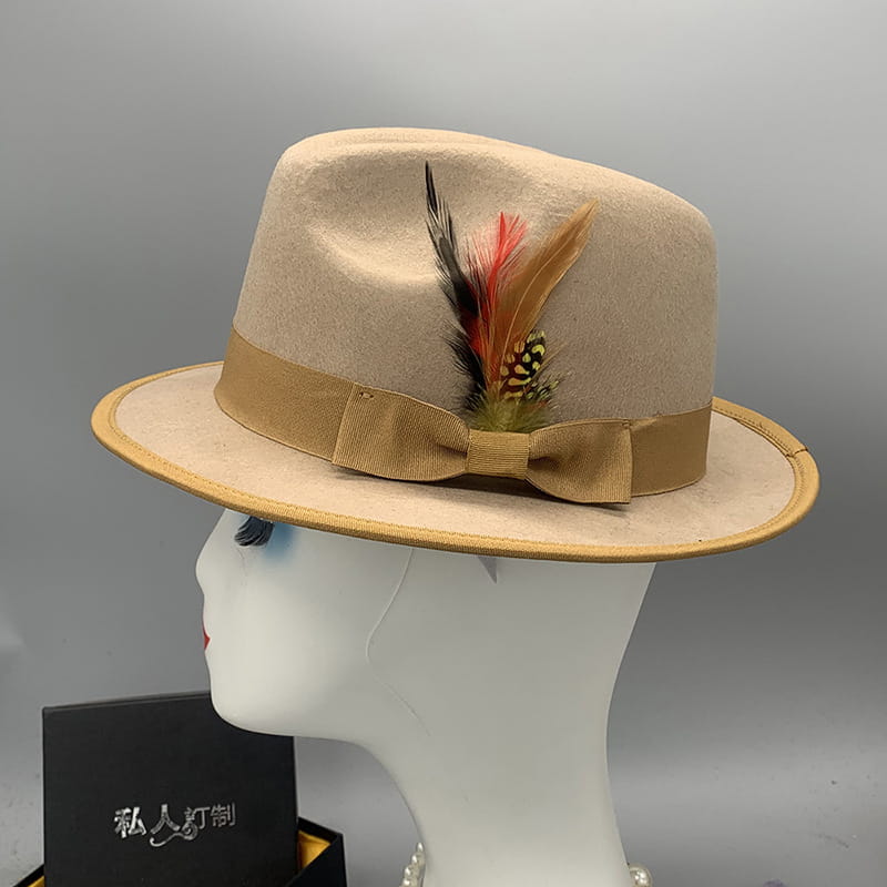 Beige woolen felt fedora hat with tan ribbon bow and decorative feather accent for unisex use.