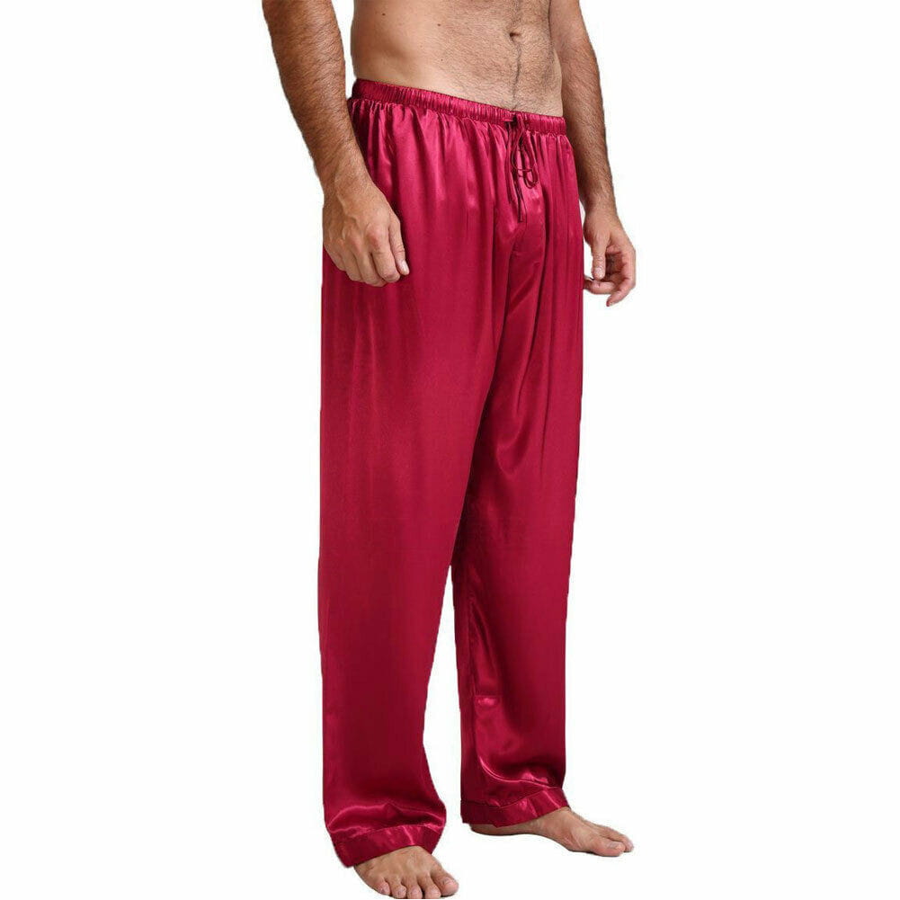pantalons de pyjama en satin de soie pour homme rouges, en satin de soie, avec taille élastique et cordon de serrage, conçus comme des bas de nuit amples.
