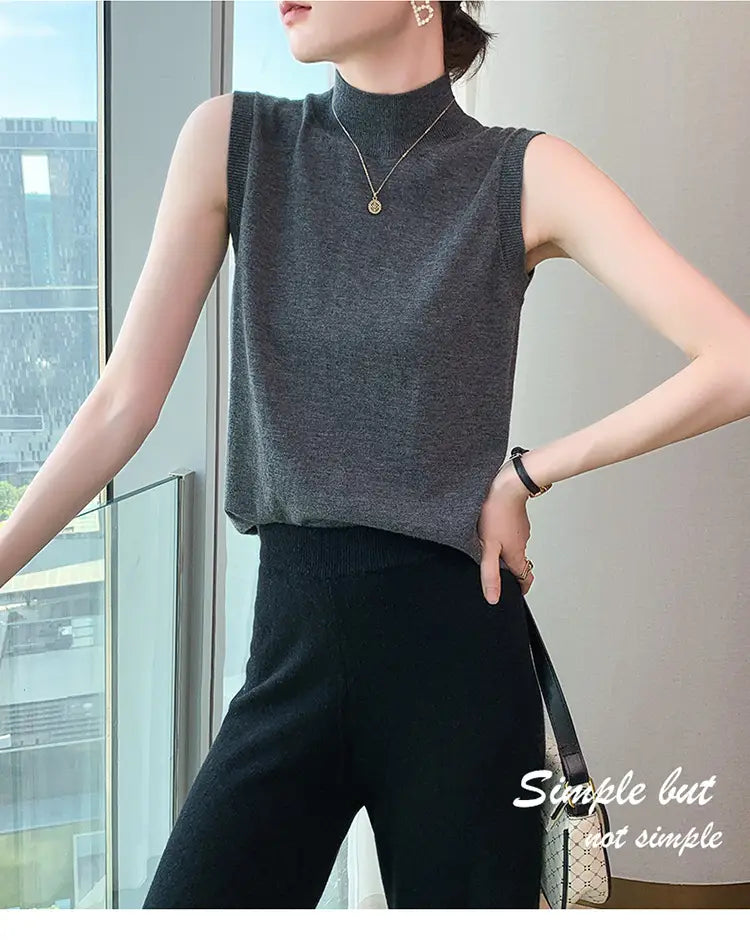 Gray sleeveless high neck knit wool sweater vest perfect for layering in cool weather.