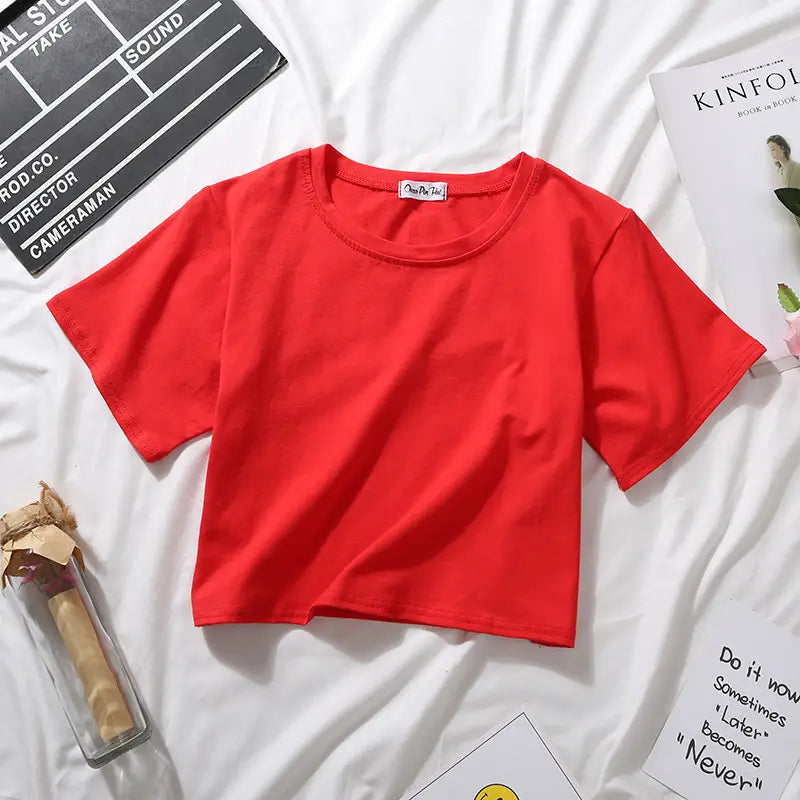 A vibrant red women solid short sleeve crop top casual t-shirt made of soft fabric with a simple round neckline.