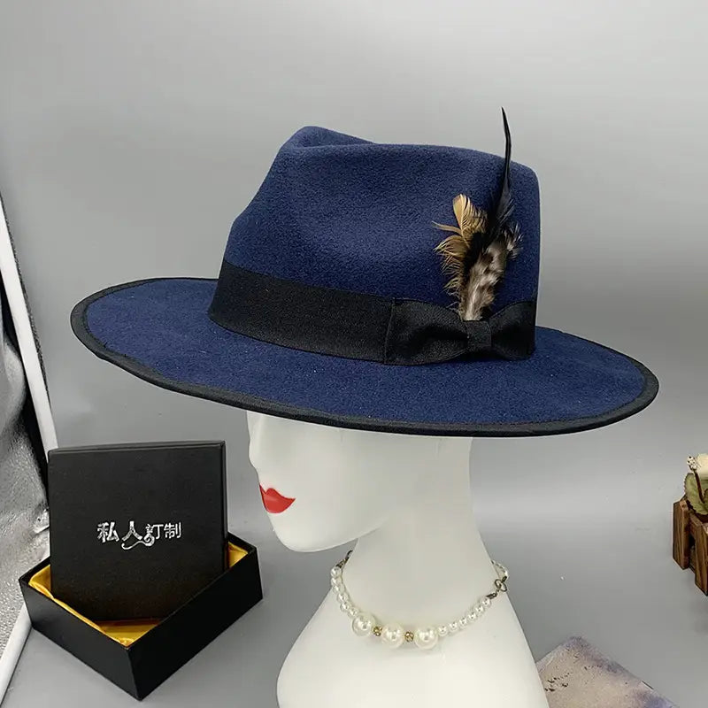 Deep blue unisex woolen felt fedora hat with black satin ribbon bow and decorative feather accent.