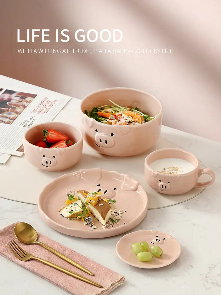 Pastel pink ceramic dinnerware set featuring adorable pig face designs on each piece from the cute pig ceramic dinnerware set.
