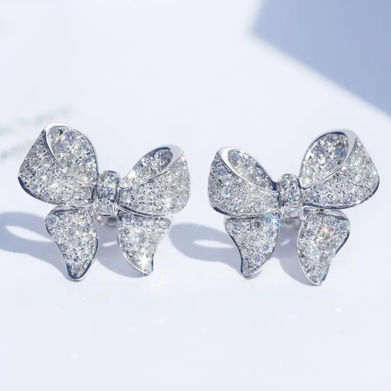 sparkling silver bow-shaped earrings adorned with a dense pavé of clear faceted zircon gemstones from the silver bowknot zircon necklace and earrings set.