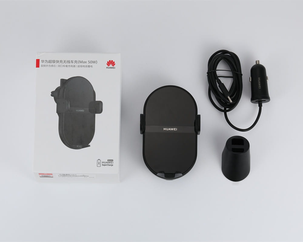 Black Huawei 50w wireless car charger with sleek oval-shaped design and integrated phone holder for hands-free charging.
