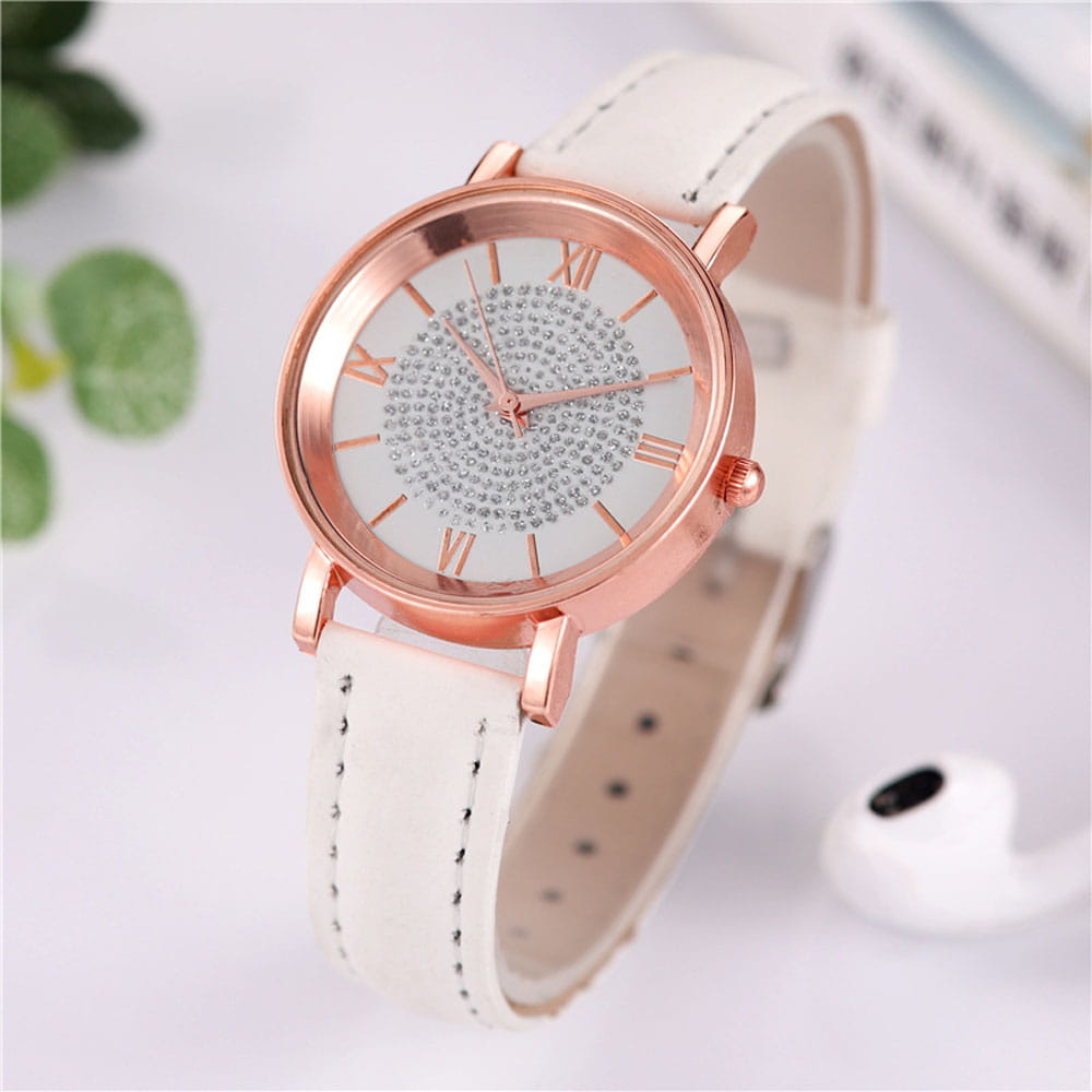 Rose gold crystal quartz women watch with a white leather strap and a dial adorned with sparkling rhinestones and roman numeral hour markers.