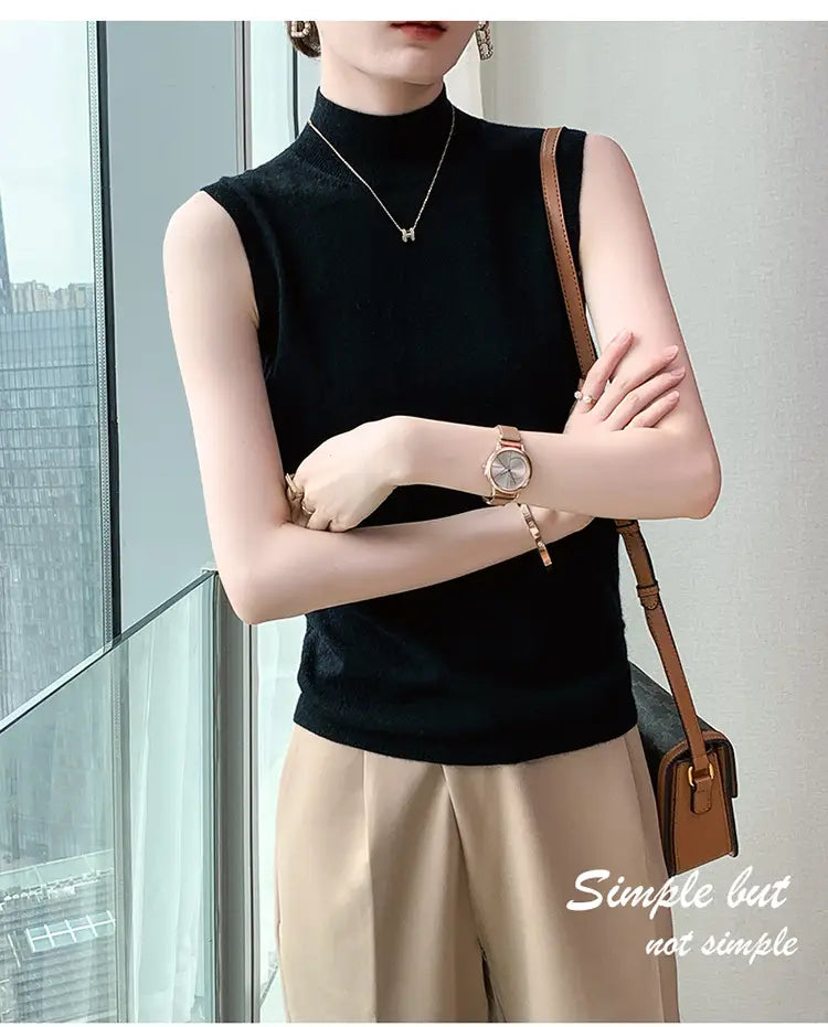Black sleeveless wool turtleneck sweater vest made of knit fabric, ideal for layering or formal wear.
