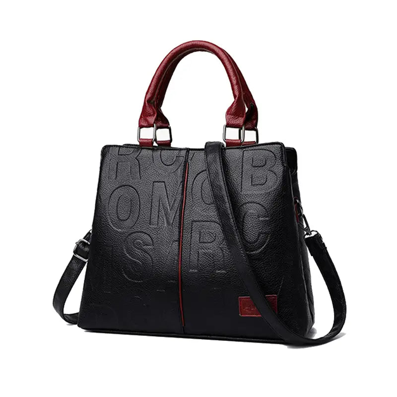 Black crossbody handbag in black pu leather with embossed lettering and contrasting red handles shoulder strap and accent patches style1 style2.
