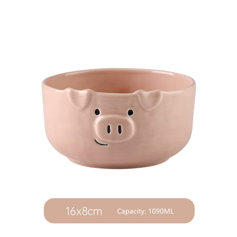 A blush pink ceramic pig-shaped bowl with black dot eyes and a smiling mouth from the cute pig ceramic dinnerware set.