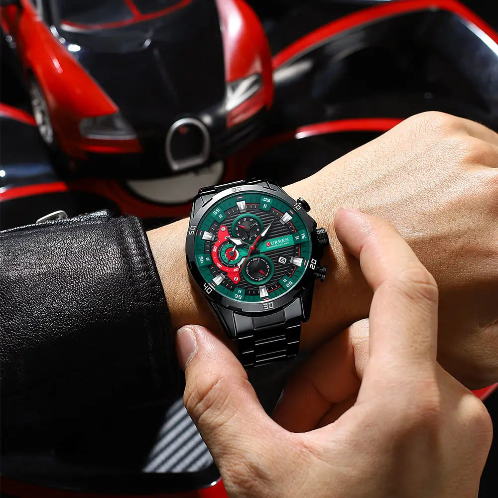 Curren men black green chronograph stainless steel watch with red accents on the dial and a metallic bracelet.