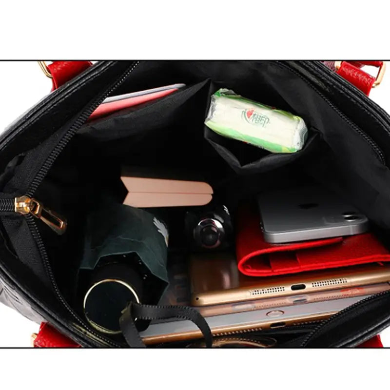 Red and black handbag with gold-tone hardware and a structured black fabric-lined interior made of pu leather in style1 style2 satchel design.