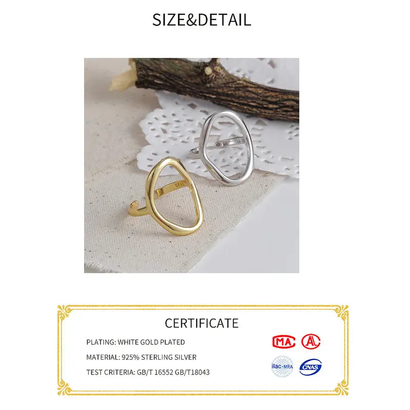 A sleek, open oval sterling silver ring for women with a polished white gold plated finish and 925 sterling silver base.
