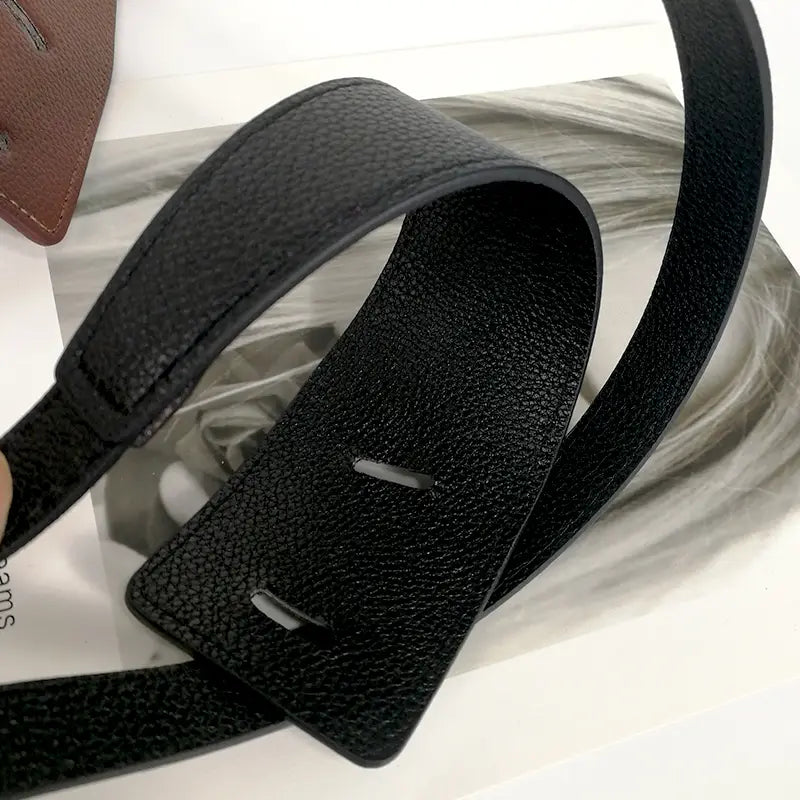 Black textured pu leather strap with a rectangular buckle featuring two horizontal slots for the women’s wide pu leather knot waist belt.