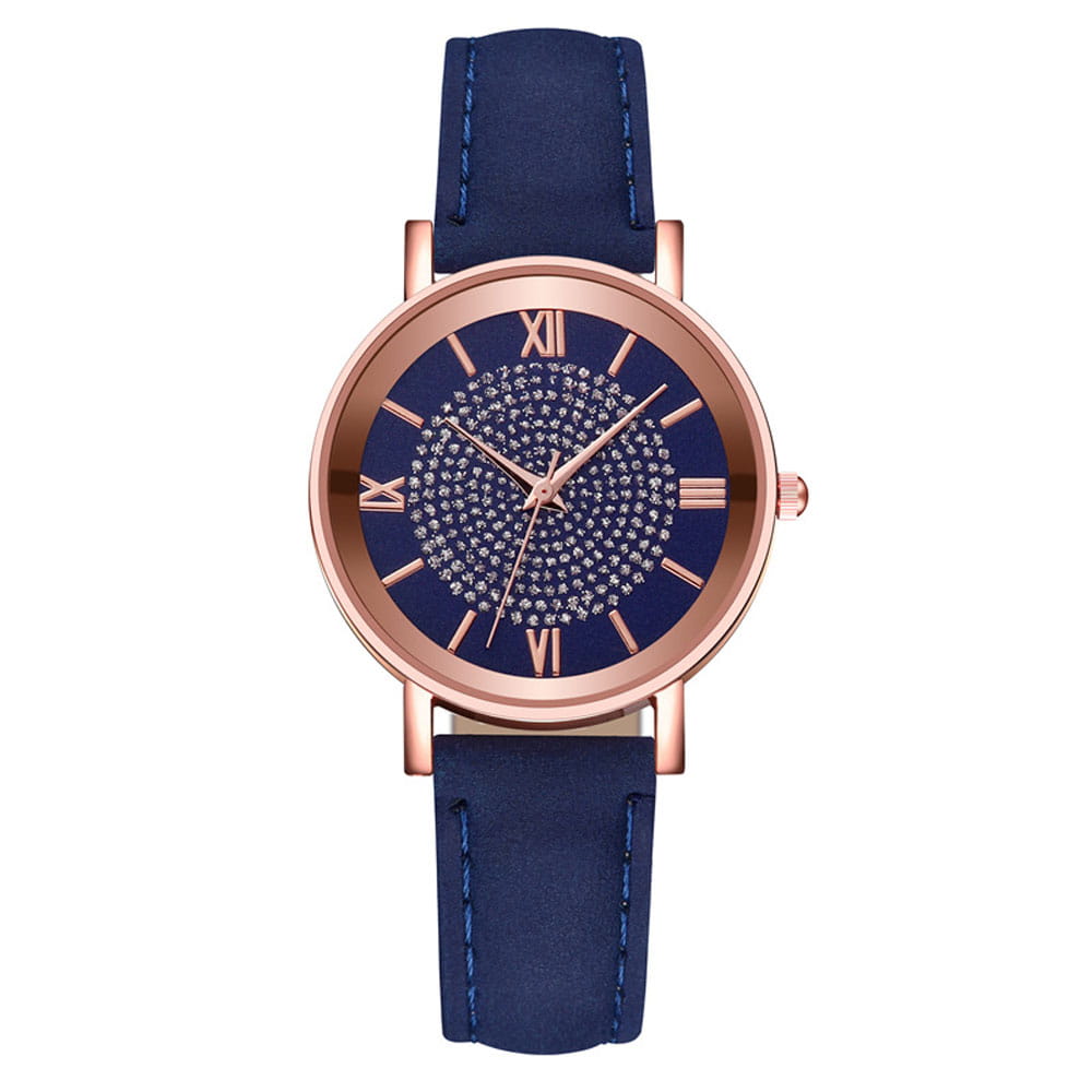 A rose gold crystal quartz women watch with a navy blue leather strap, rose gold case, roman numeral hour markers, and a sparkling crystal-encrusted dial.
