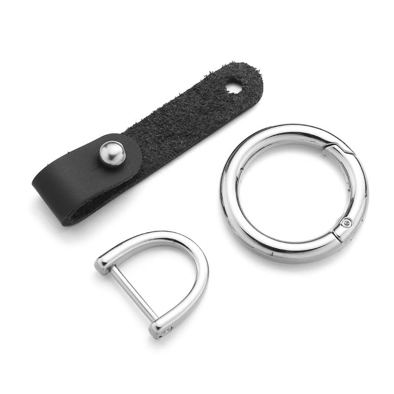 Black leather car keychain with silver hardware featuring a leather strap with a silver-toned metal snap button and polished stainless steel d-ring and circular carabiner.