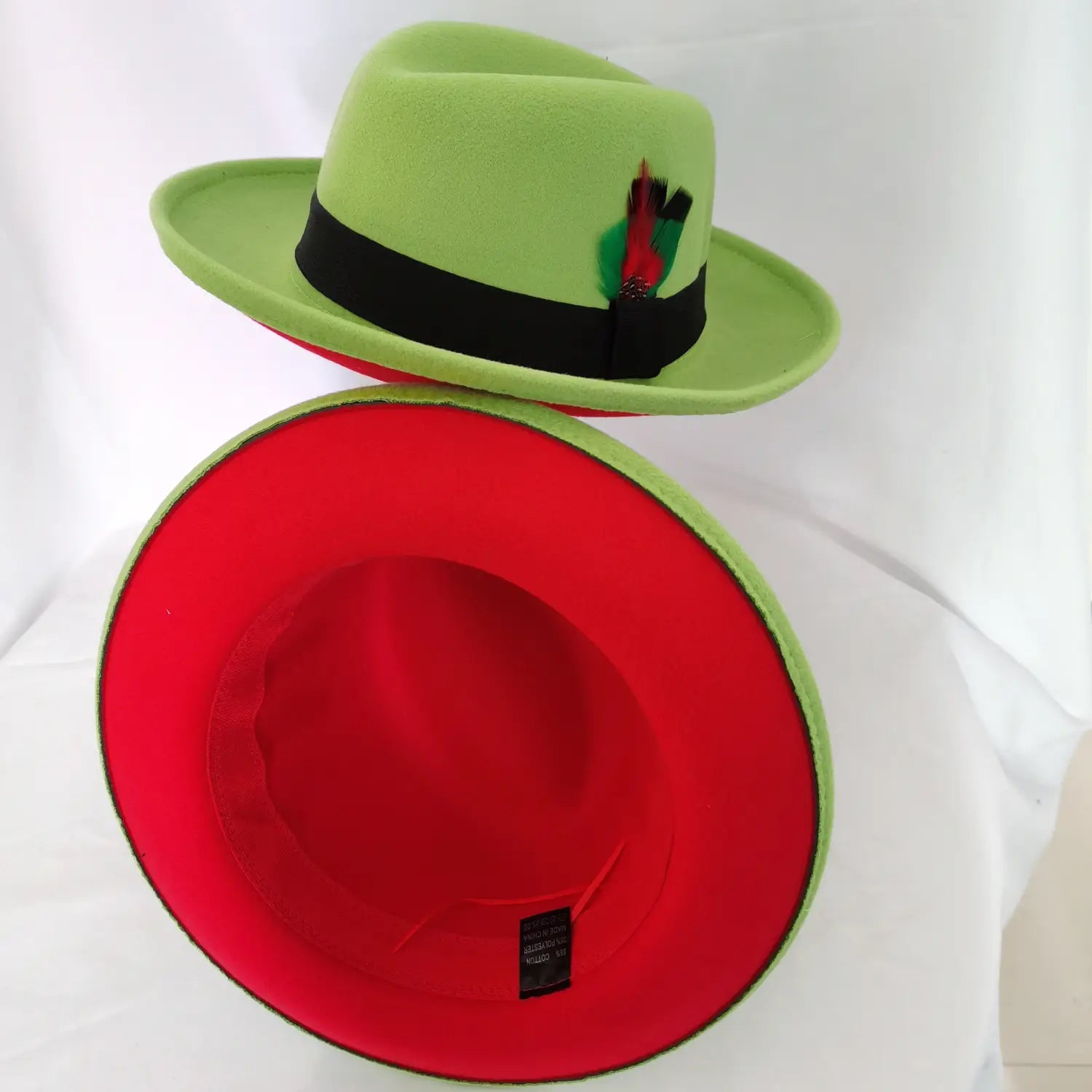 Unisex woolen felt fedora hat in vibrant lime green featuring a black band, red feather accent, and bright red interior lining.