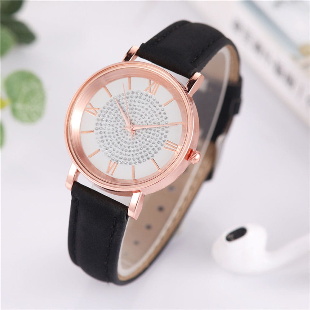 Rose gold crystal quartz women’s watch with a white face adorned with sparkling rhinestones and roman numerals, featuring a black leather strap.