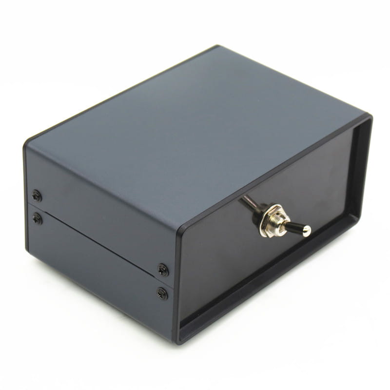 Black rectangular metal enclosure of hifi audio switcher 2 way speaker selector box with a silver toggle switch on the front.