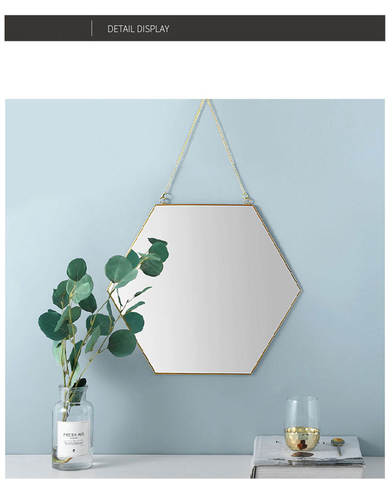 Gold hexagonal wall hanging mirror with a gold-toned metallic frame and chain suspension for decorative interior use.