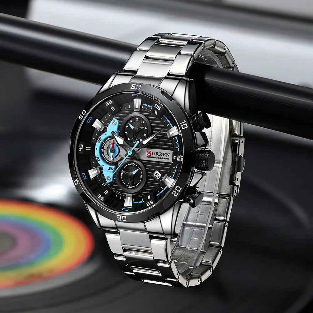 Silver-toned Curren men black green chronograph stainless steel watch with a black dial, blue accents on the subdials and hands, and a stainless steel link bracelet.