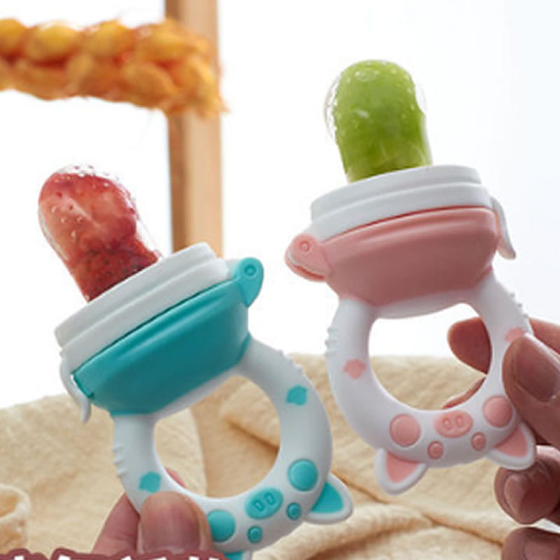 Two colorful silicone baby fruit feeder and teethers in playful cat and pig shapes featuring strawberry and green fruit designs for safe teething.