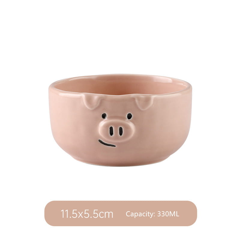 Pastel pink ceramic bowl shaped like a pig with black dot eyes snout and smiling mouth from the cute pig ceramic dinnerware set.