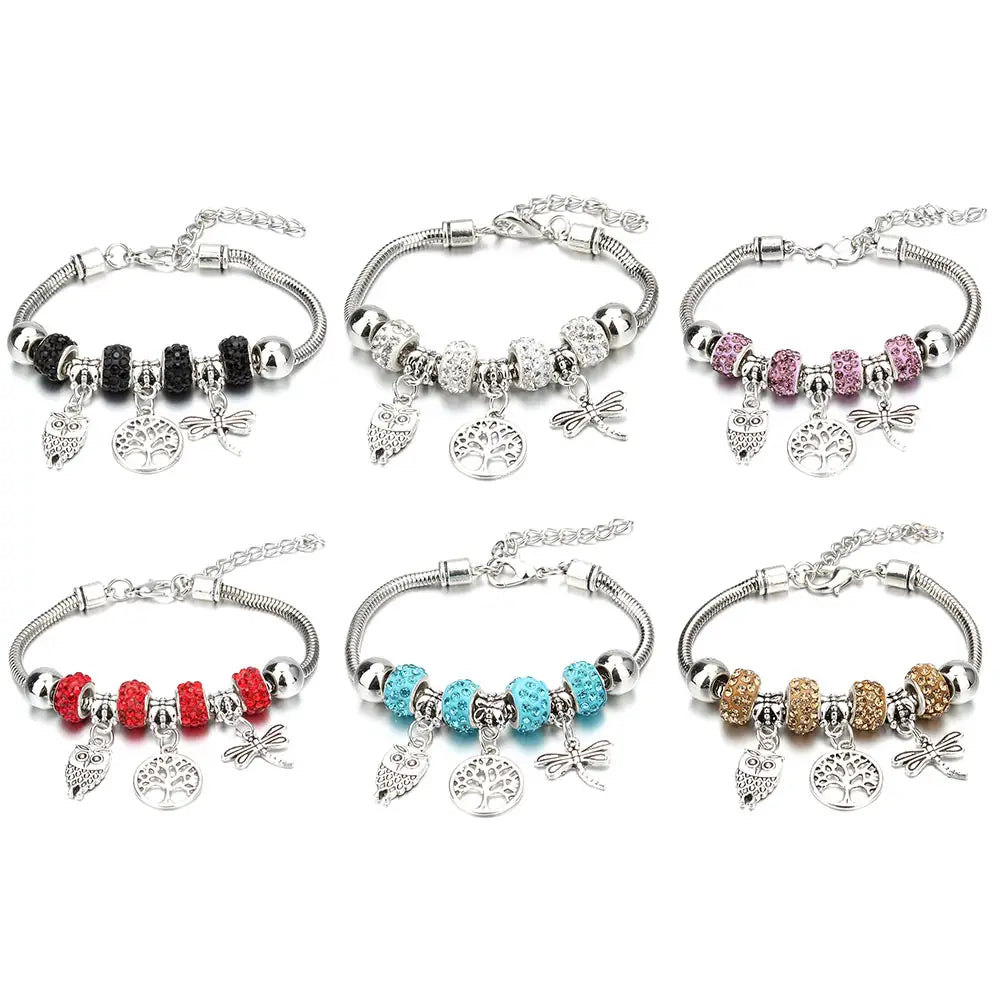six silver-toned beaded bracelets featuring charm bracelets with owl tree and dragonfly charms designed for women including crown and key motifs.