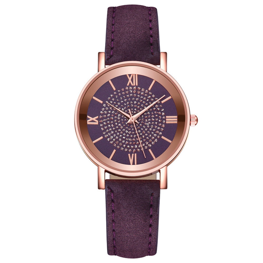 A rose gold crystal quartz women watch with a dark purple dial adorned with sparkling crystals and roman numerals, paired with a matching suede leather strap.