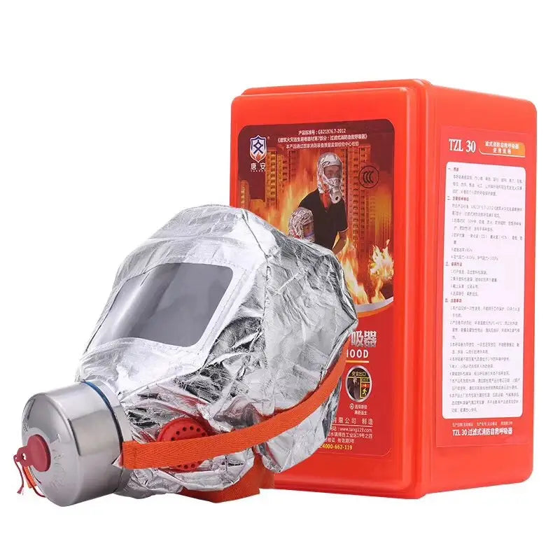Silver foil-wrapped fire escape mask 30 minute protective respirator with red straps and metallic cylinder base displayed beside an orange storage box