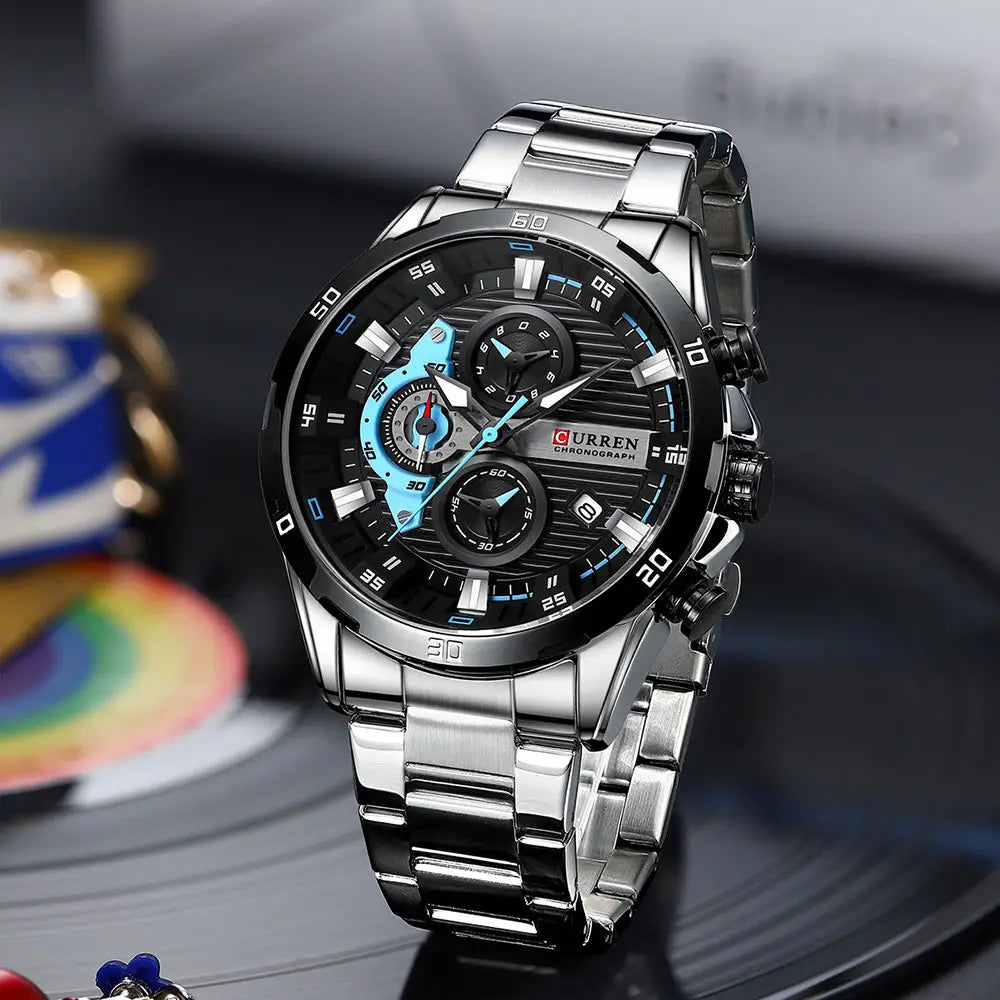 silver-toned curren men black green chronograph stainless steel watch with a black dial featuring blue accents on the subdials and hands and a stainless steel link bracelet