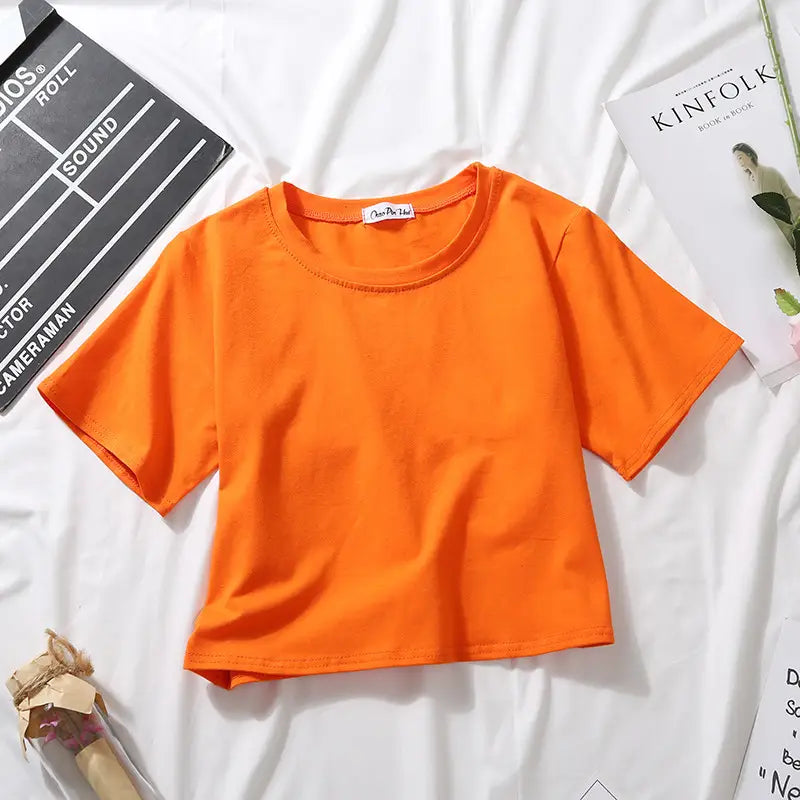 Bright orange solid short sleeve crop top t-shirt for women with a round neckline perfect for casual wear.