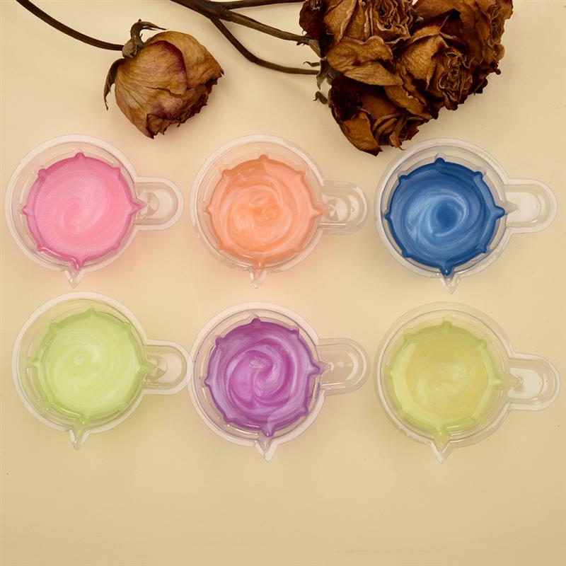 six small clear plastic cups arranged in two rows containing vibrant swirls of colorful gel-like epoxy resin as part of an epoxy resin mixing tool set for diy jewelry making