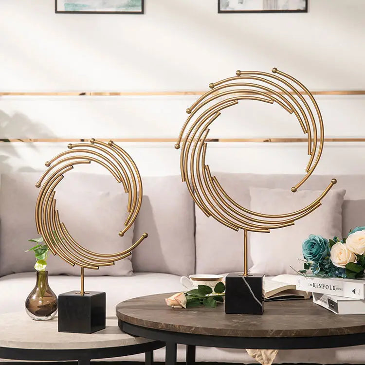 gold metal abstract sculpture office desk decor featuring gold-toned metal circular sculptures on black marble bases